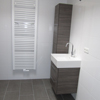 Badkamer renovatie compleet met inloopdouche, ligbad, design badkamermeubel, tegelwerk en lichtkoepel.